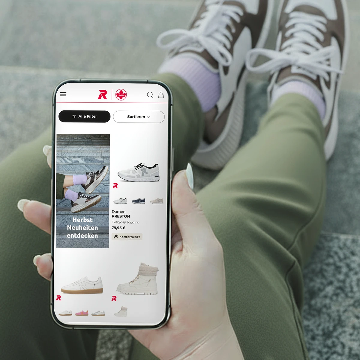 Rieker E-Commerce-Website-Vorschau auf einem Smartphone mit den „Herbst Neuheiten“ sowie dem Sneaker „Damen PRESTON“ neben Lifestyle-Produktfotografie